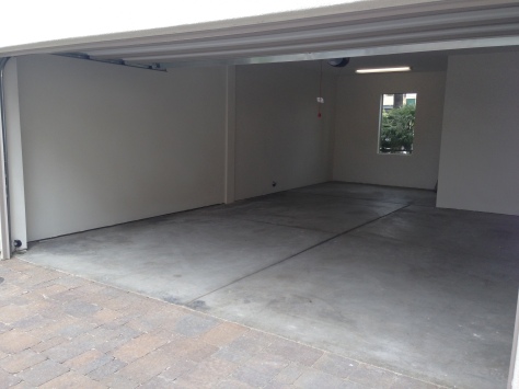 Some garages are larger than what you'd find in most homes! This one is a full 2-car garage with a "storage" area in the front that can be used for an exercise room or small 3rd car.